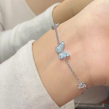 Set: Halskette und Armband mit leuchtend blauem Schmetterling